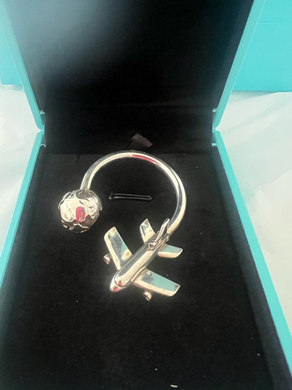 Tiffany and Co Silver Airplane and Globe keychain.